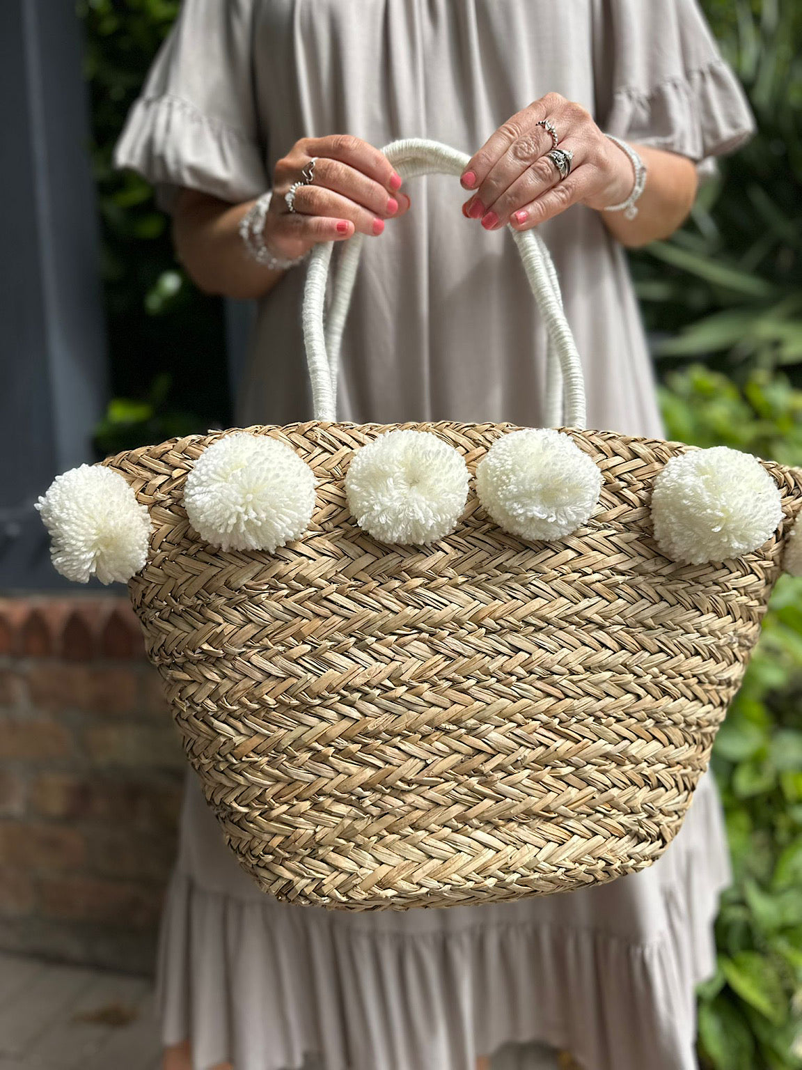 Straw beach tote with pom poms online